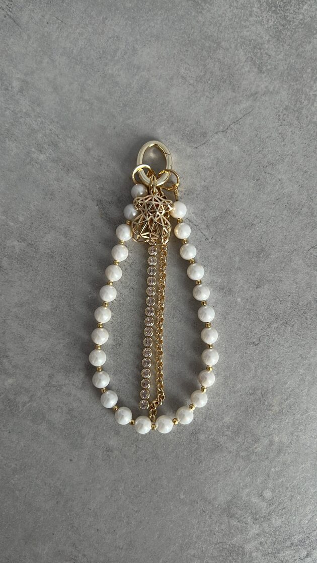 Baltā pērlīte ar elegantu dizainu, piemērota rotājumiem un aksesuāriem.