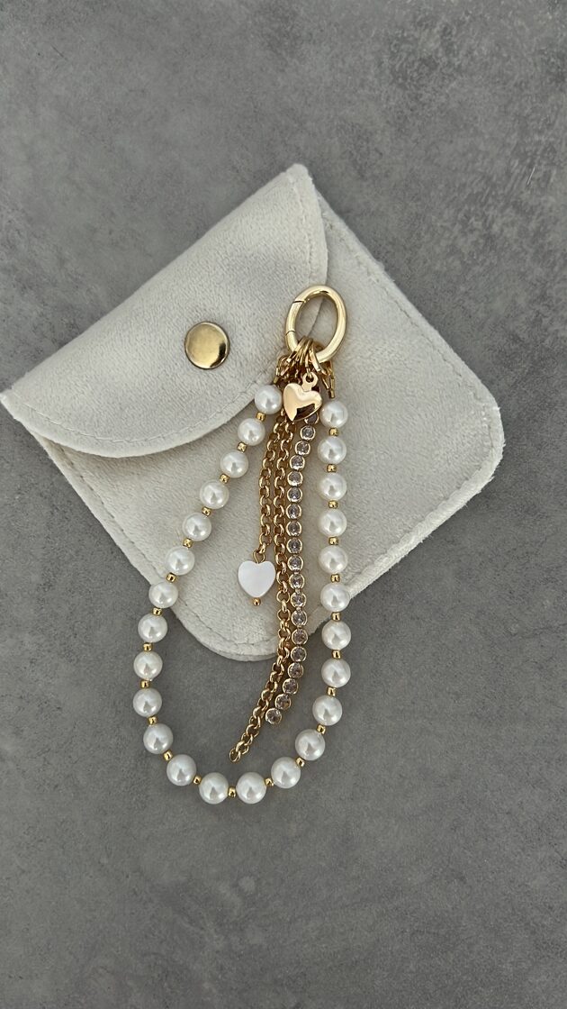 Baltā pērle ar 12 ķēdītēm, elegants rotājums, kas papildina jebkuru stilu.