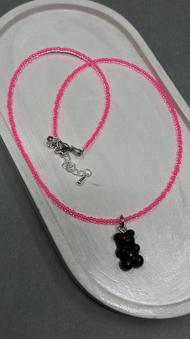 Neon rose choker with black rubber, a stylish accessory that gives a modern appearance.