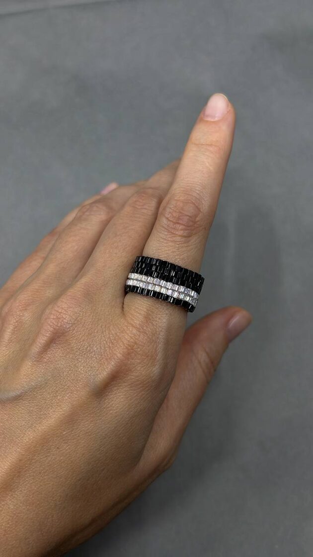 Gredzens ar melniem un baltajiem cukura kristāliem, piešķir eleganci un unikālu stilu.